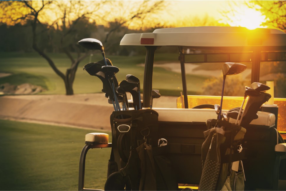 Golf cart with a sunset on the greens